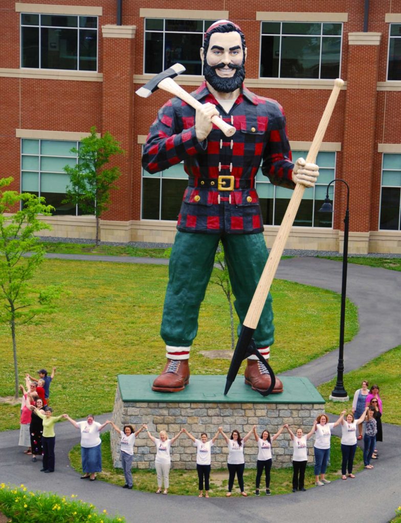 Our team holds hands in a circle around the Paul Bunyan statue in Bangor, Maine